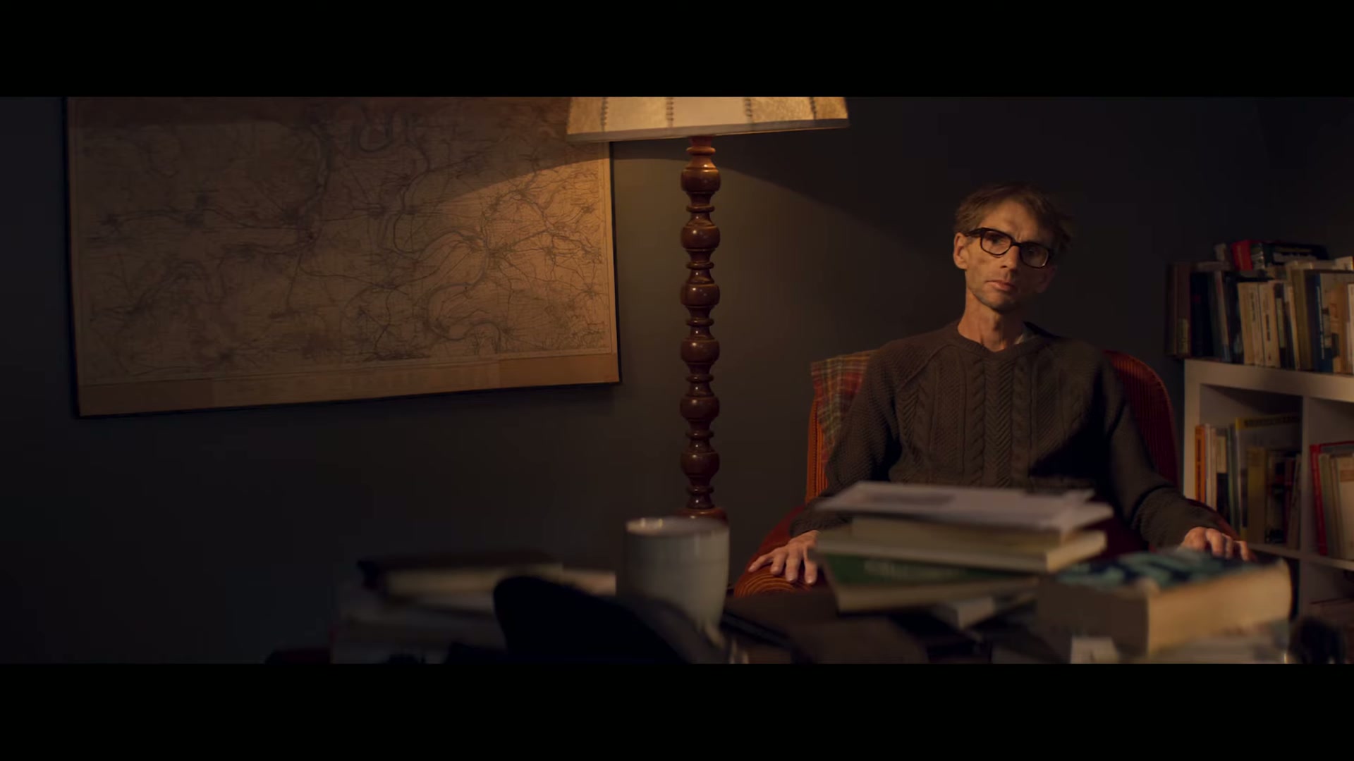 Leo at his desk beneath a wall map
