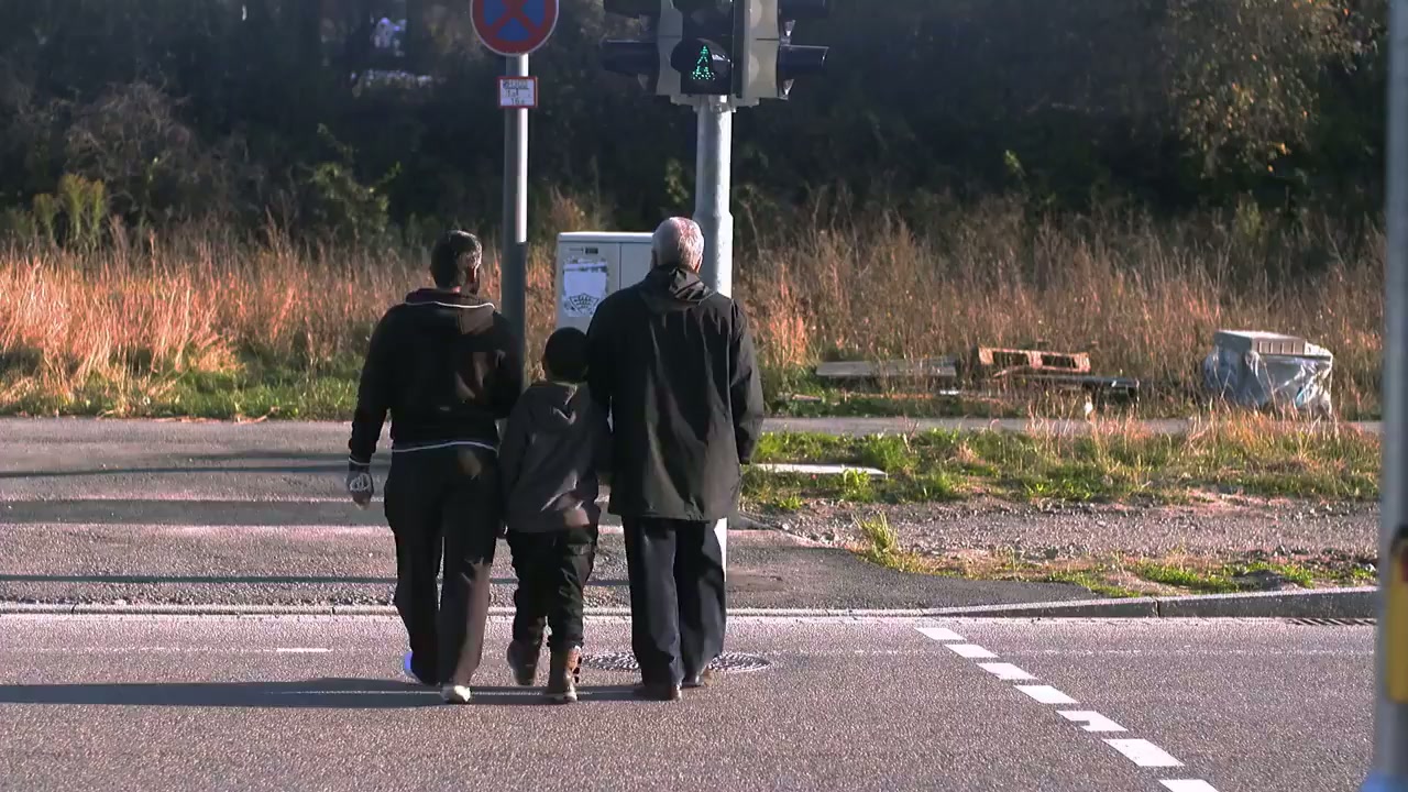 A family walking along a road in their new home town