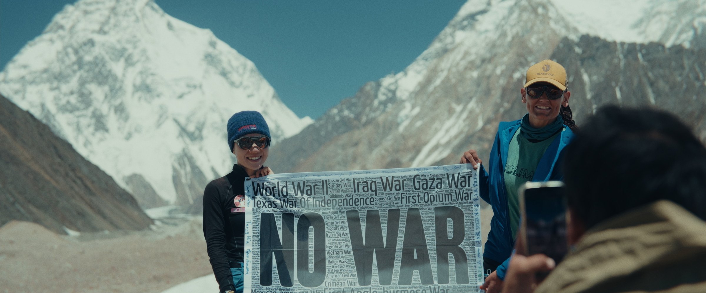 Hong Trinh and Vibi with the “NO WAR” flag