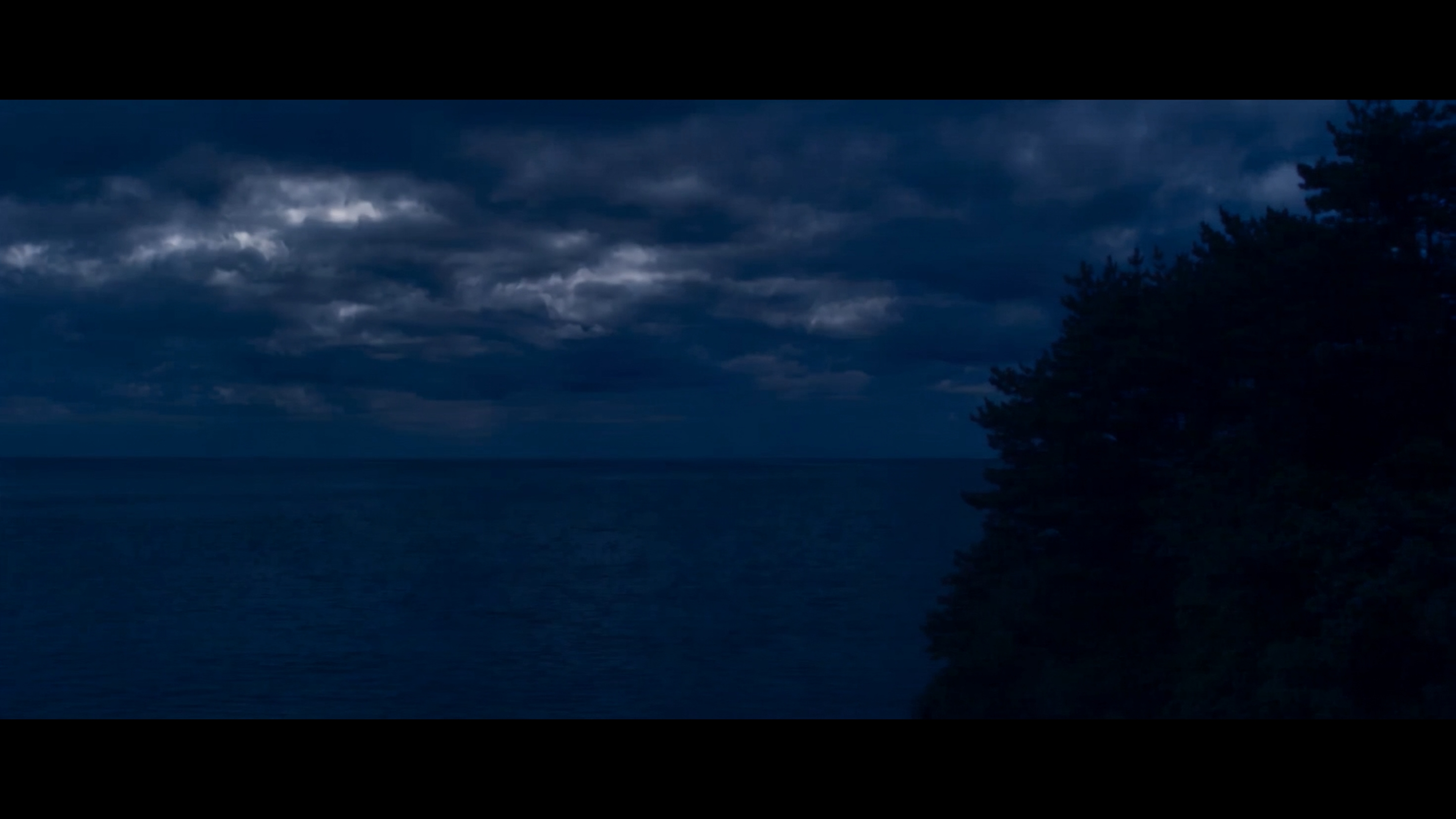 The night ocean seen through a window
