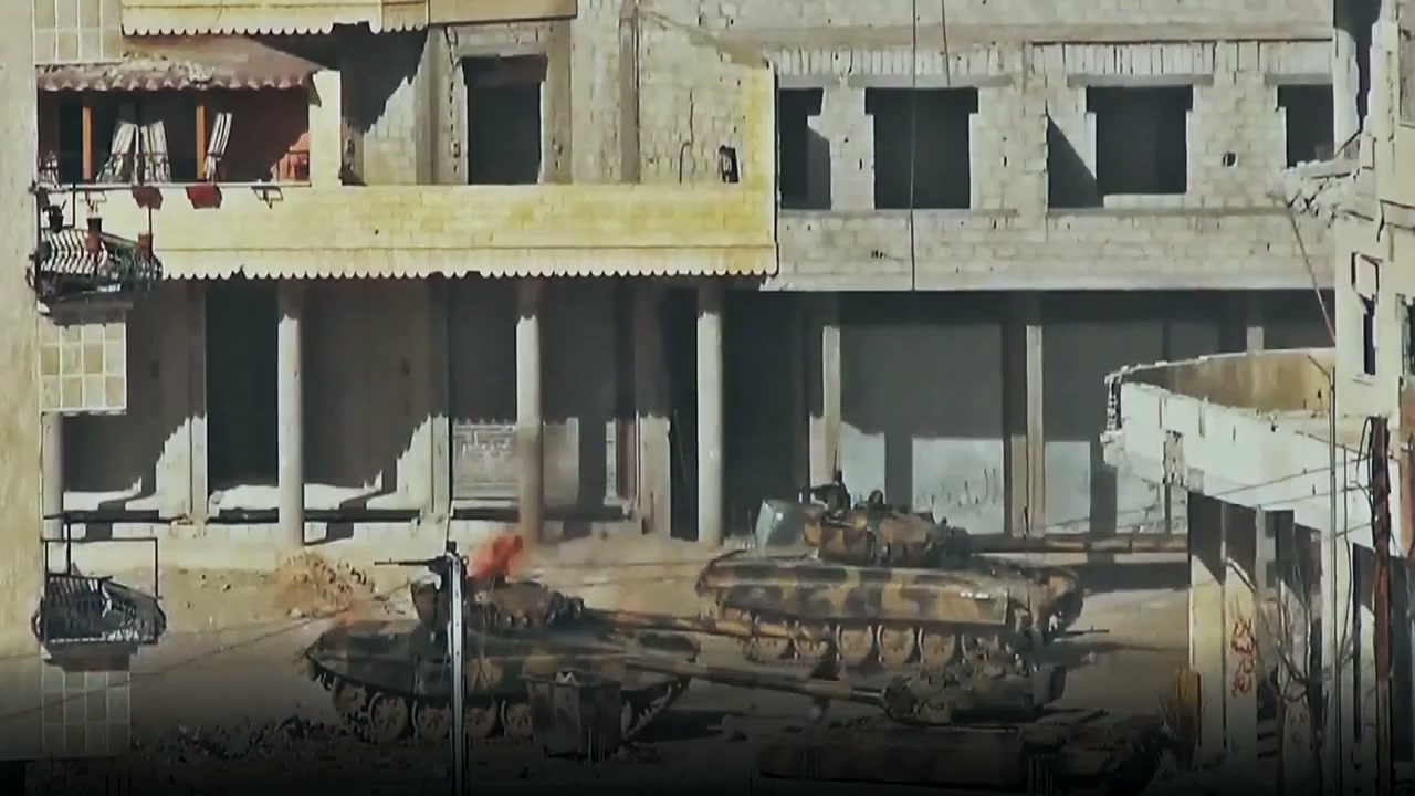 A destroyed street in Syria with a tank in the rubble
