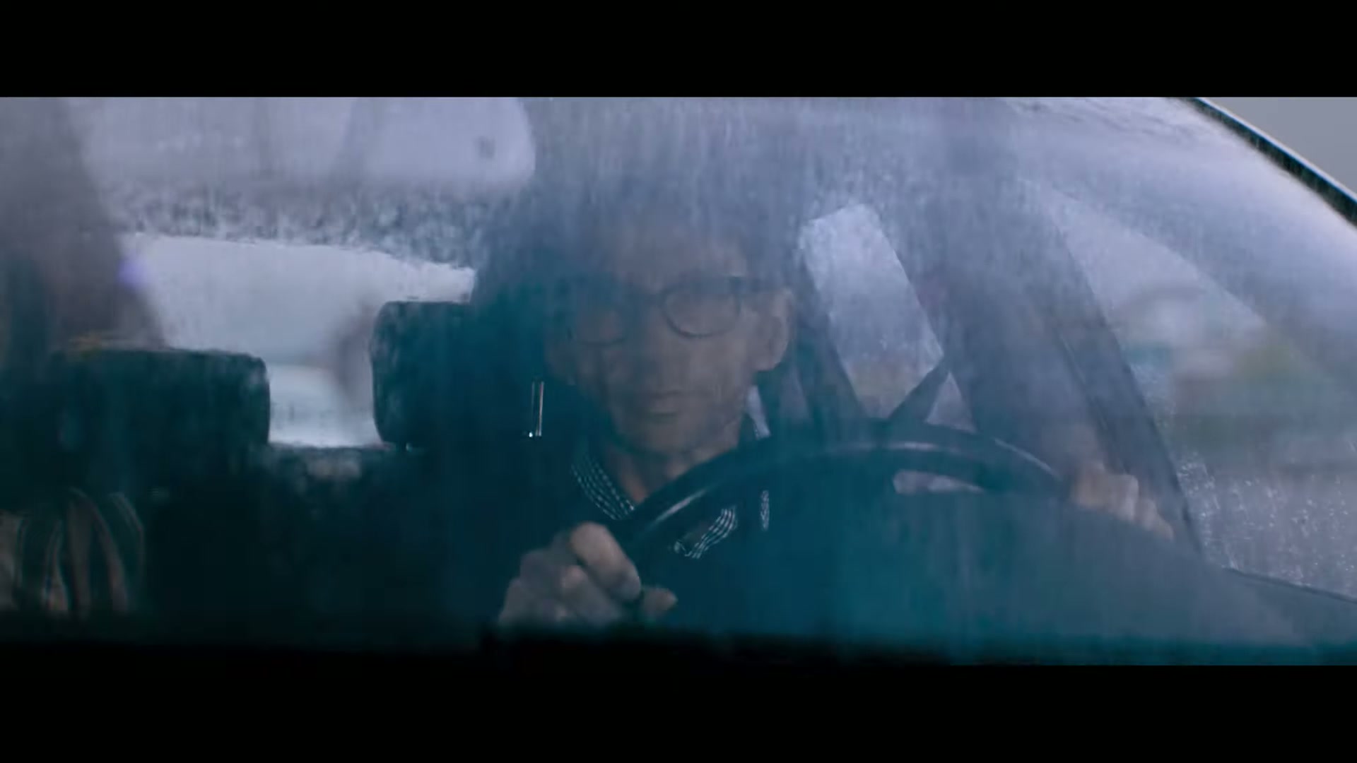 Driving through rain behind a wet windscreen